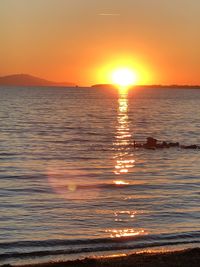 Scenic view of sea against romantic sky at sunset