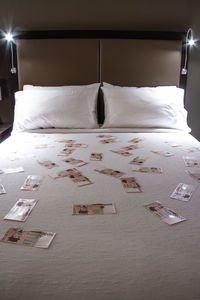 Close-up of illuminated lighting equipment on bed at home