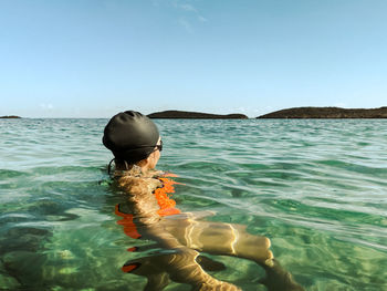 Portrait of man swimming in sea against sky