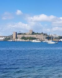 Scenic view of sea by city against sky