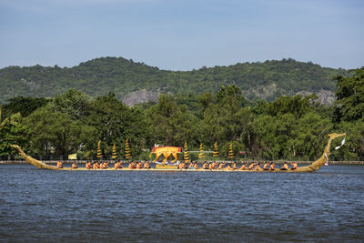 Boats in sea against mountain