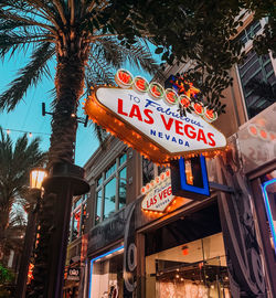 Low angle view of illuminated sign at night