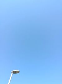 Low angle view of street light against clear blue sky