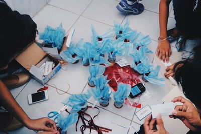 High angle view of people with artwork on floor