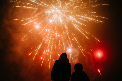 Low angle view of firework display at night