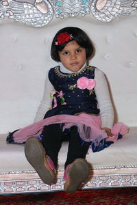 Portrait of cute girl sitting on floor