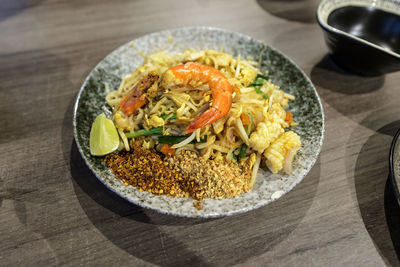 High angle view of pad thai served in plate on table