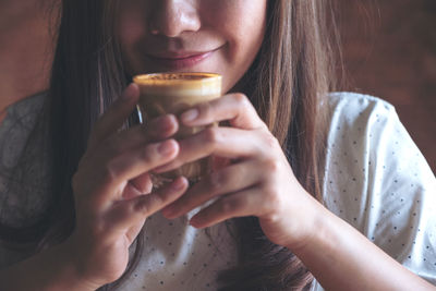 Close-up portrait of woman drinking glass