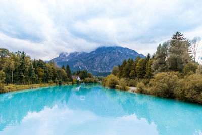 Scenic view of lake and mountains against sky