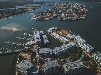 High angle view of cityscape by sea against sky