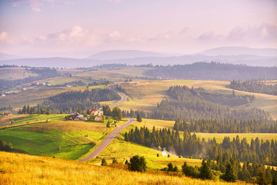 Mountain road summer sunset. curved asphalt road hills. pieniny beskidy range, border poland ukraine