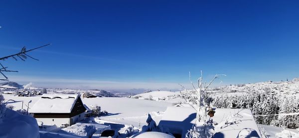 Snow covered field against sky