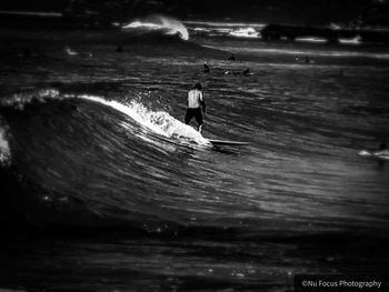 Rear view of man in sea