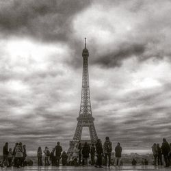 Eiffel tower against cloudy sky