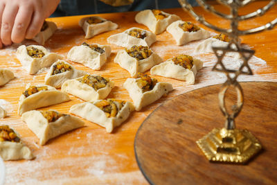 Cropped hand of person preparing food on table