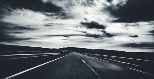 Road passing through dramatic sky