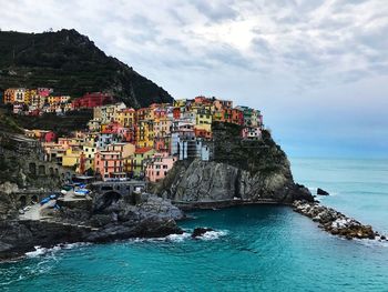 Panoramic view of sea and buildings against sky