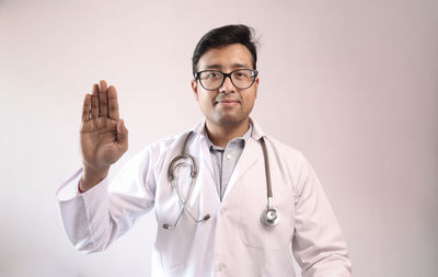 Young man standing against white background