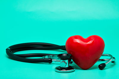 Close-up of heart shape on blue table