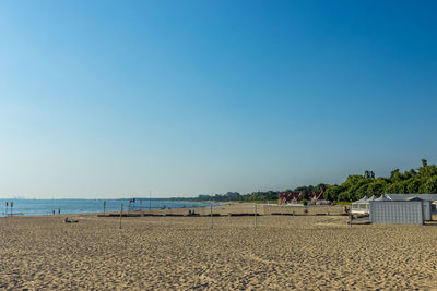 Scenic view of beach against clear blue sky