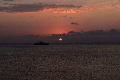 Scenic view of sea against orange sky
