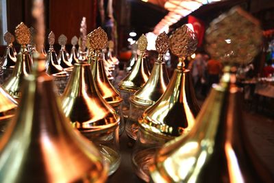 Close-up of gold colored antiques for sale at market