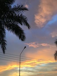 Low angle view of silhouette palm trees against sky during sunset