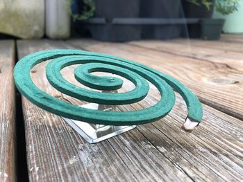 Close-up of burning mosquito coil on table