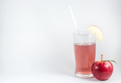 Red wine glass against white background