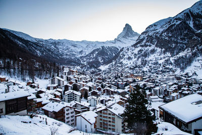 Snow covered houses and buildings in city