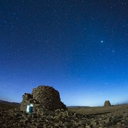 Scenic view of rocks against clear sky at night
