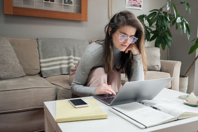 Close up of young woman working from home covid