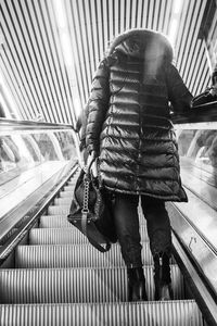 Low section of woman on railing in city