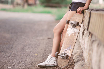 Low section of girl with skateboard