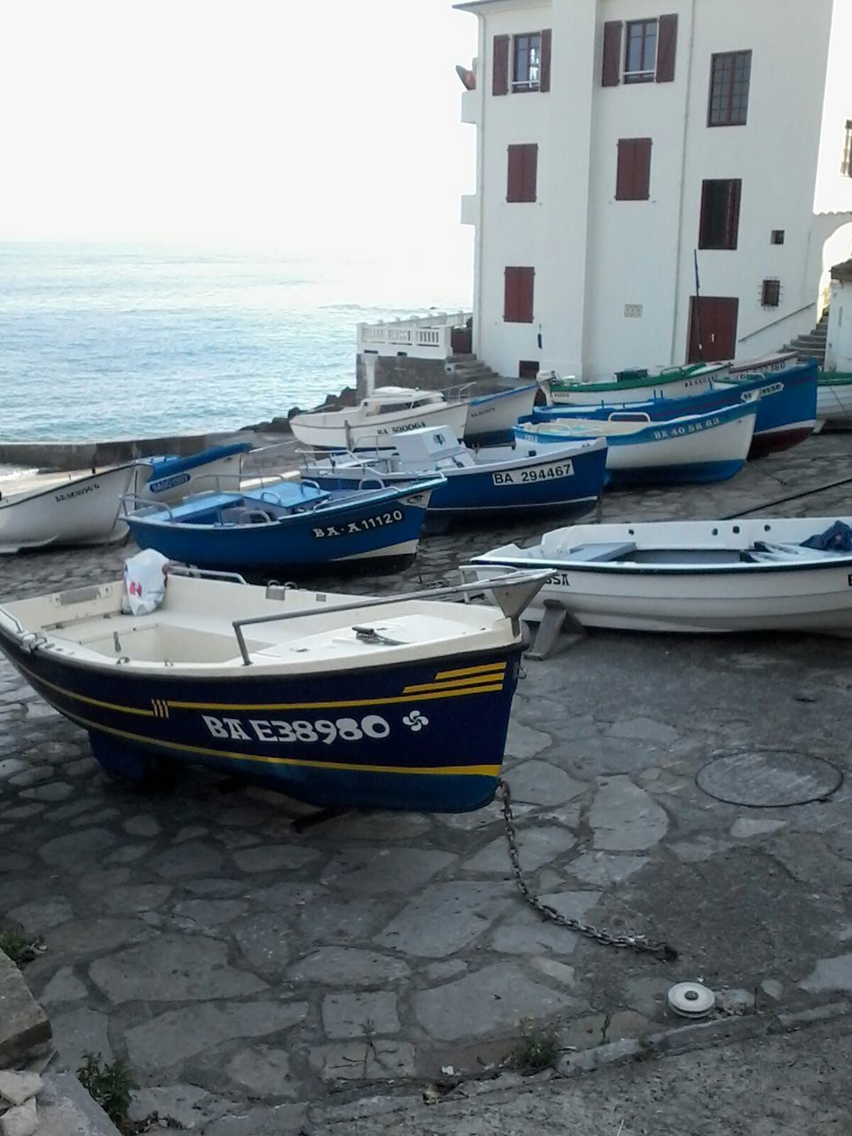 nautical vessel, moored, transportation, mode of transport, boat, water, sea, building exterior, sky, day, built structure, outdoors, horizon over water, beach, no people, shore, travel, nature, harbor, architecture