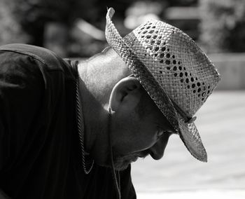 Side view of man wearing hat