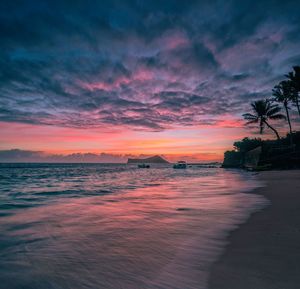 Scenic view of sea against romantic sky at sunset