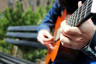 Cropped image of man playing guitar