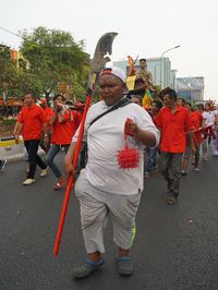 Rear view of people standing on road