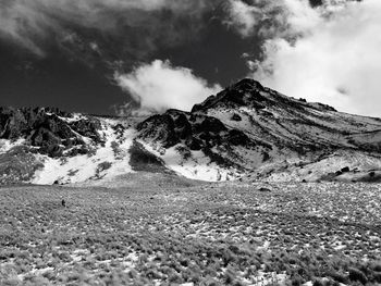 Scenic view of mountains against cloudy sky