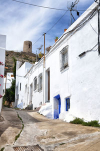 Street amidst buildings against sky