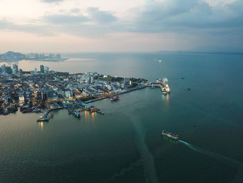 Ferry carry passenger and transport arrive penang georgetown in dusk hour.