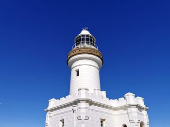 Low angle view of lighthouse against clear blue sky