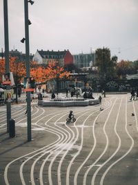 People walking on road against buildings