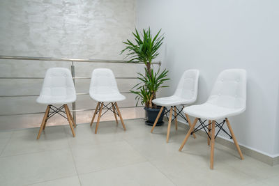 Table and chairs against wall