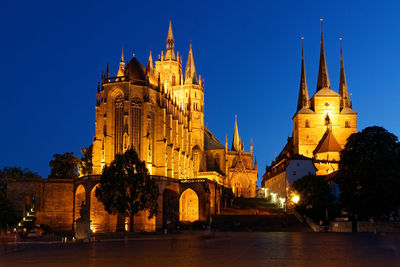 View of illuminated buildings against sky at dusk