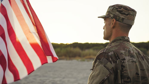 Low angle view of man holding flag