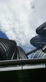 Low angle view of modern building against cloudy sky