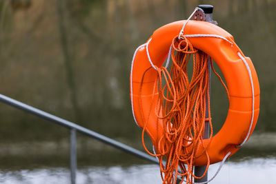 Close-up of rope tied to over lake