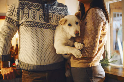 Midsection of woman holding dog